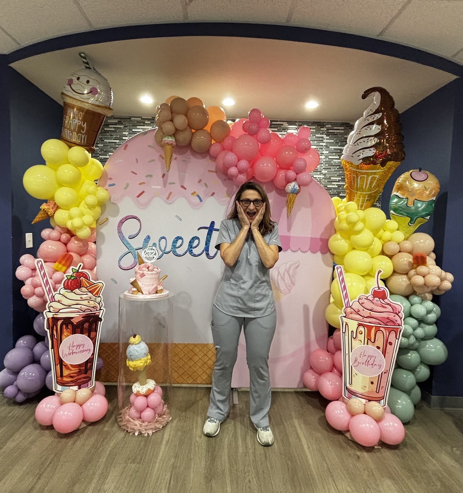 A festive ice-cream-themed balloon arch set up at Simply Smiles to celebrate a patient milestone